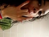 College girl fingers in the bathroom and taste her sweet cum