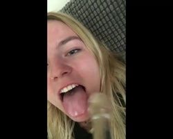 Short clip of a naught blonde girl toying with a glass dildo and licking up her cum