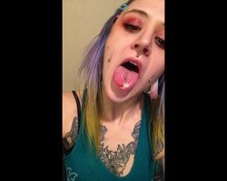 Tatted girl plays with her vaginal grool on her split tongue 