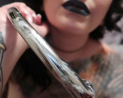 Tatted goth chick bates with her curved metal dildo and eats her juicy vaginal juice